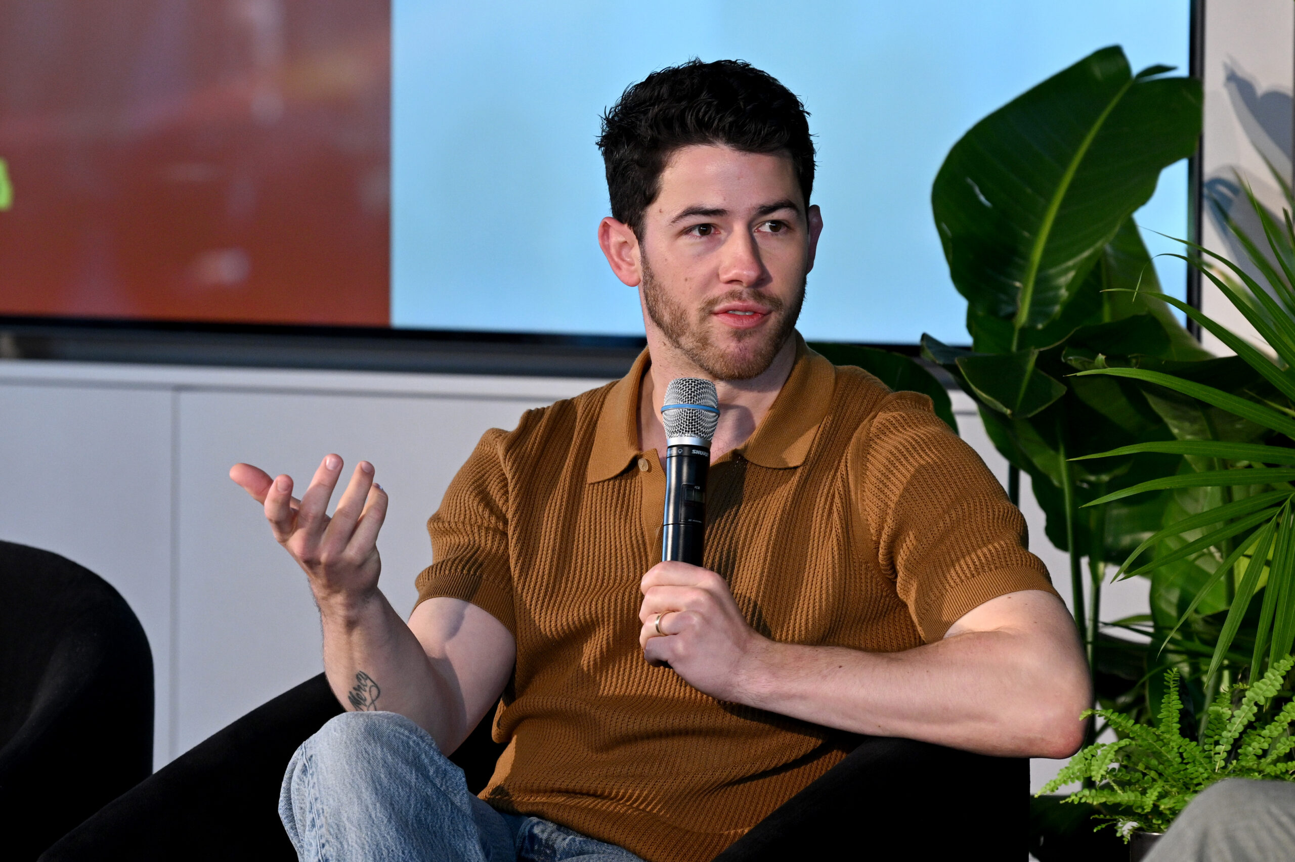 Nick Jonas speaking onstage.