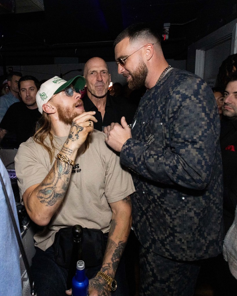 Travis Kelce chats with fellow TEU co-founder George Kittle inside the party.