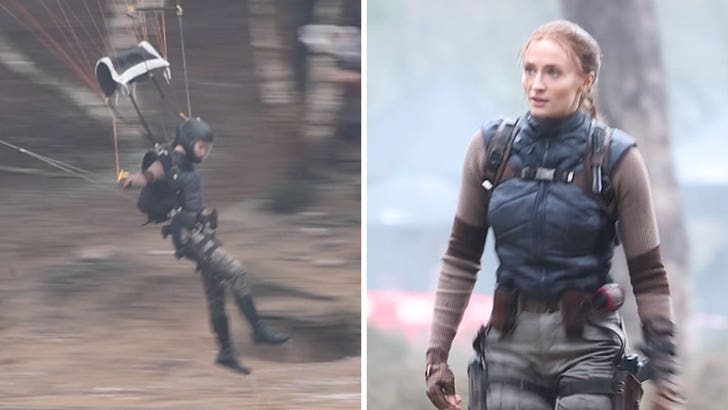 Sophie Turner strapped into a parachute rig on a windy English beach while filming Tomb Raider stunt sequence