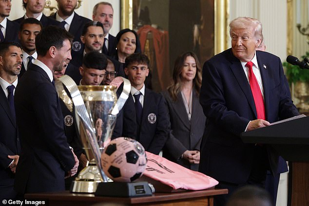 President Trump at the podium addressing Lionel Messi and Inter Miami, with the MLS Cup trophy visible