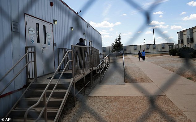 South Texas Family Residential Center in Dilley, Texas, seen through a chain-link fence
