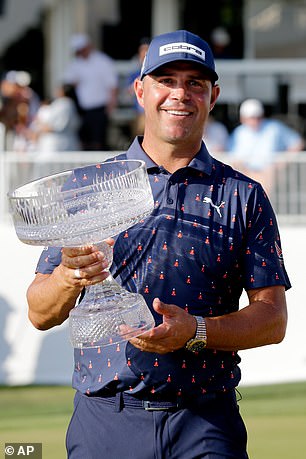 Gary Woodland holds the Houston Open trophy after his five-shot win.
