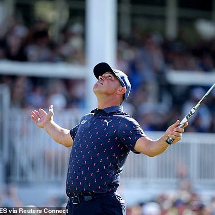 As his putt dropped on the 18th hole, Woodland spread his arms wide and looked to the skies - Daily Mail