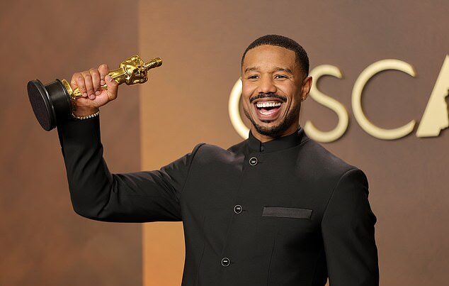 An Oscar winner raises the statuette during the ceremony