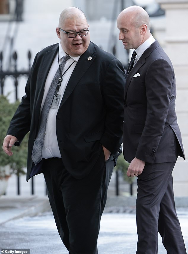 Steven Cheung, White House communications director, walks into the White House with Stephen Miller on January 28, 2025