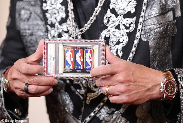 Close-up of O'Leary's custom jeweled pendant featuring the 2004-05 Upper Deck Exquisite Triple Logoman card (Jordan/Bryant/James)