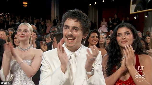 Chalamet applauds during the Oscars telecast, a standard reaction shot.