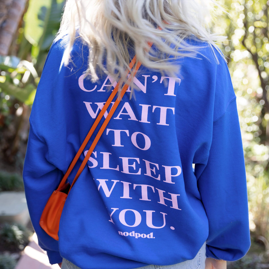 Back view of a blue Nodpod sweatshirt with the slogan "CAN'T WAIT TO SLEEP WITH YOU."