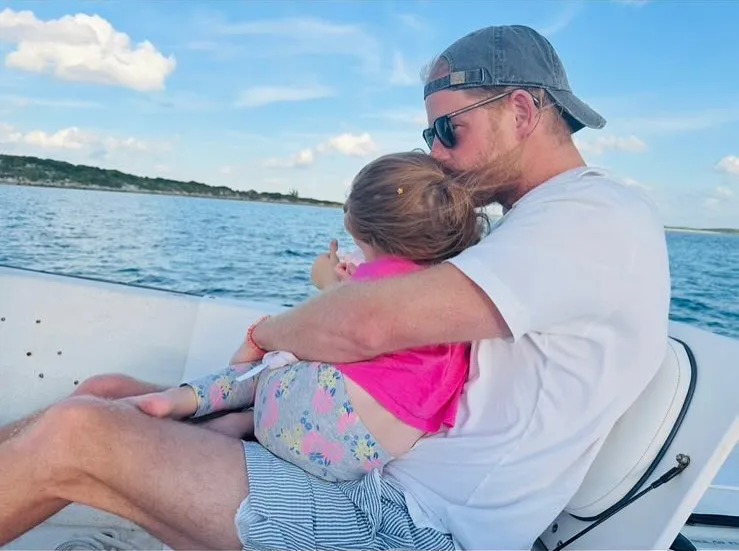 Prince Harry holds Princess Lilibet during a boat outing.