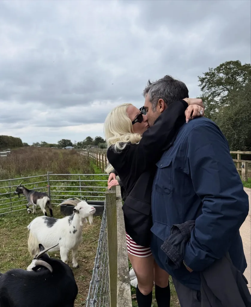 Lady Gaga kissing Michael Polansky by a goat enclosure.