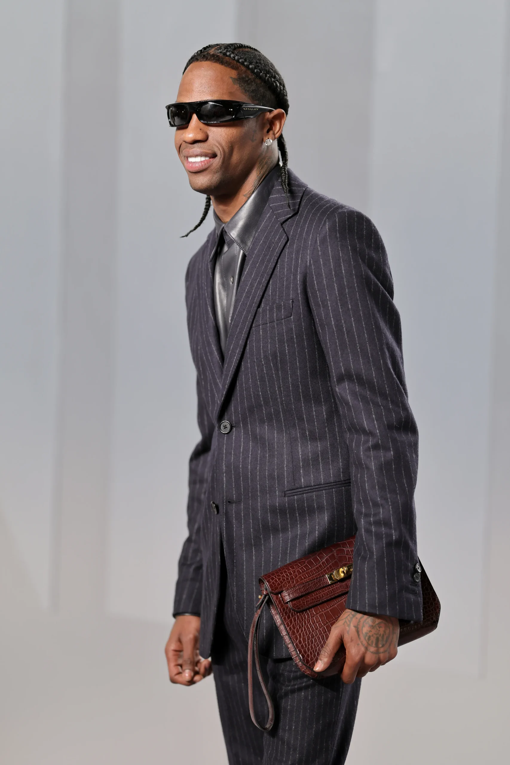 Travis Scott in a pinstripe suit at the 2026 Vanity Fair Oscar Party.