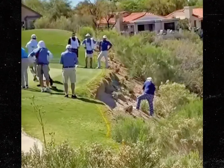 John Daly slides down a steep hillside after a shot at the Cologuard Classic in Tucson, laughing it off.
