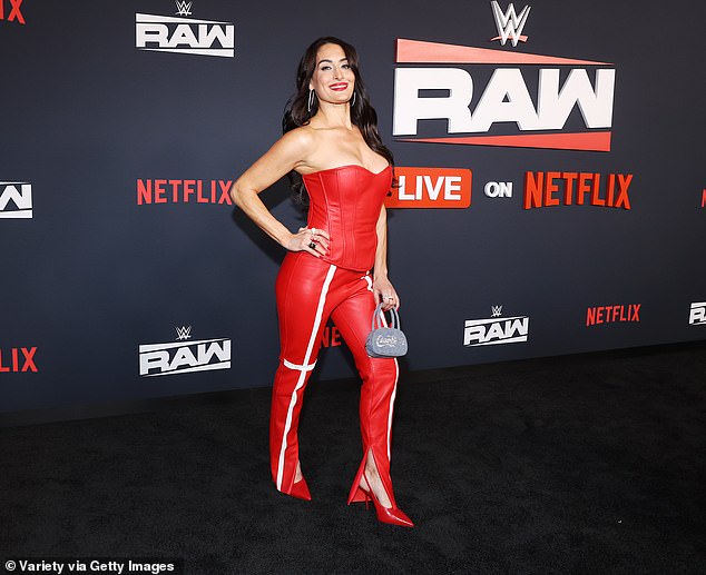 Nikki Garcia appears at a WrestleMania weekend red-carpet event wearing a protective walking boot.