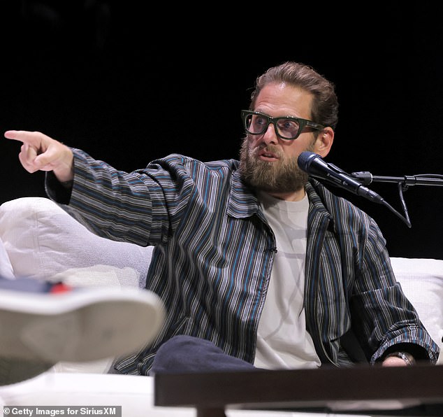 Jonah Hill on stage during a recent SmartLess live show, where he discussed moving out of Los Angeles.