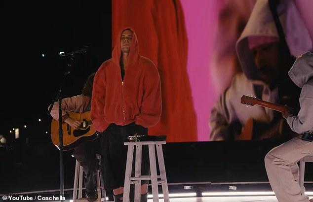 Bieber onstage in a red hoodie during his minimalist Coachella performance.