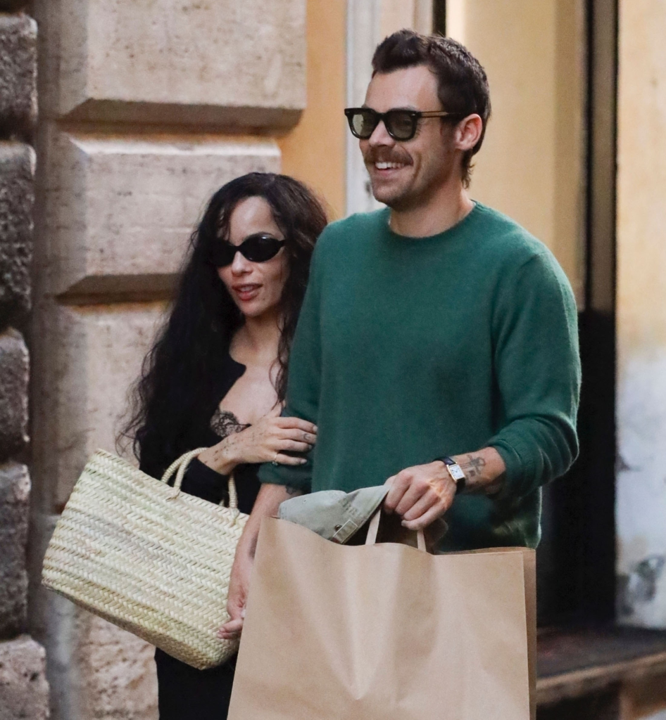 Harry Styles and Zoe Kravitz holding hands on an evening stroll in Rome; candid agency photo.
