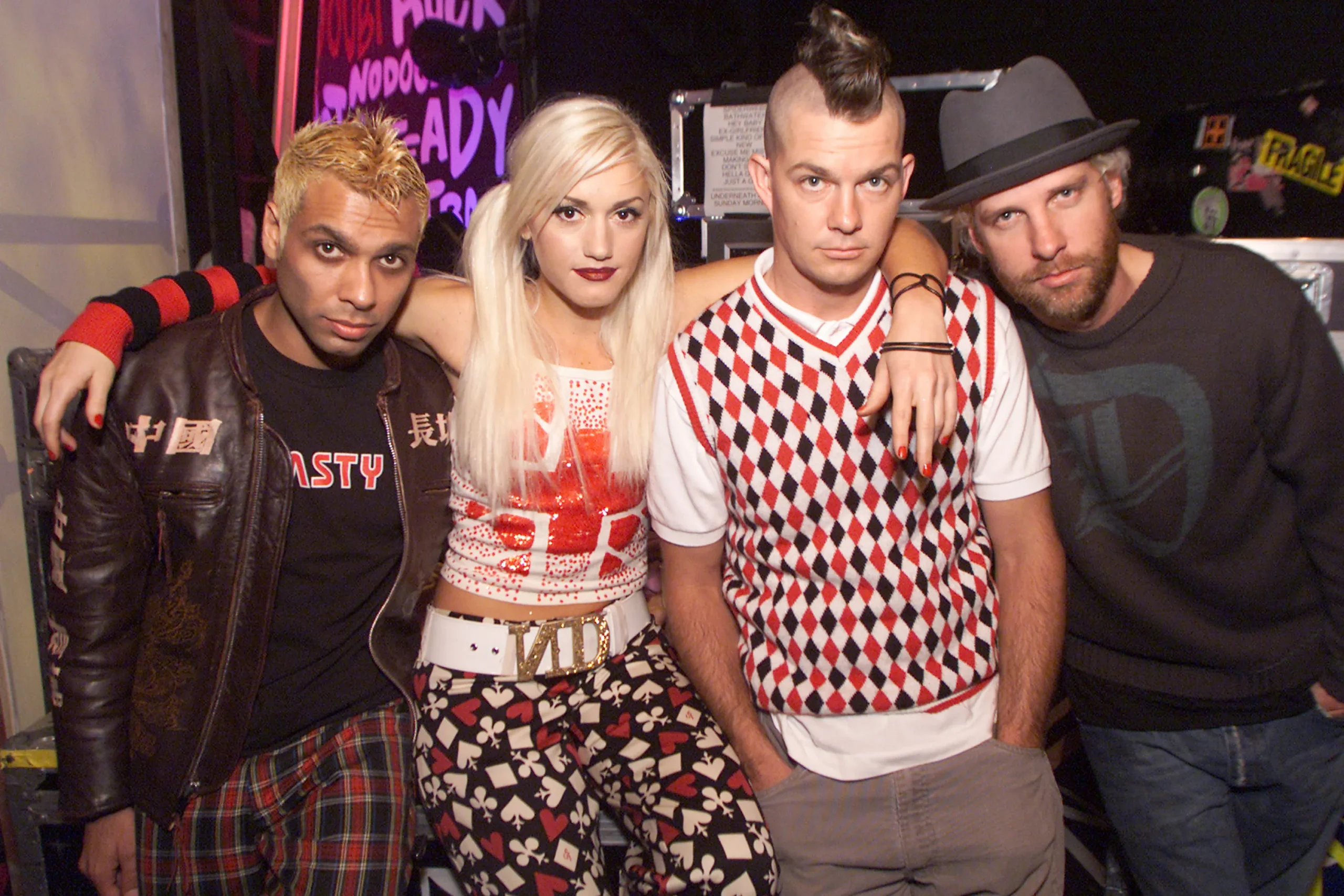 No Doubt's Gwen Stefani, Tom Dumont, Tony Kanal, and Adrian Young pose together backstage.