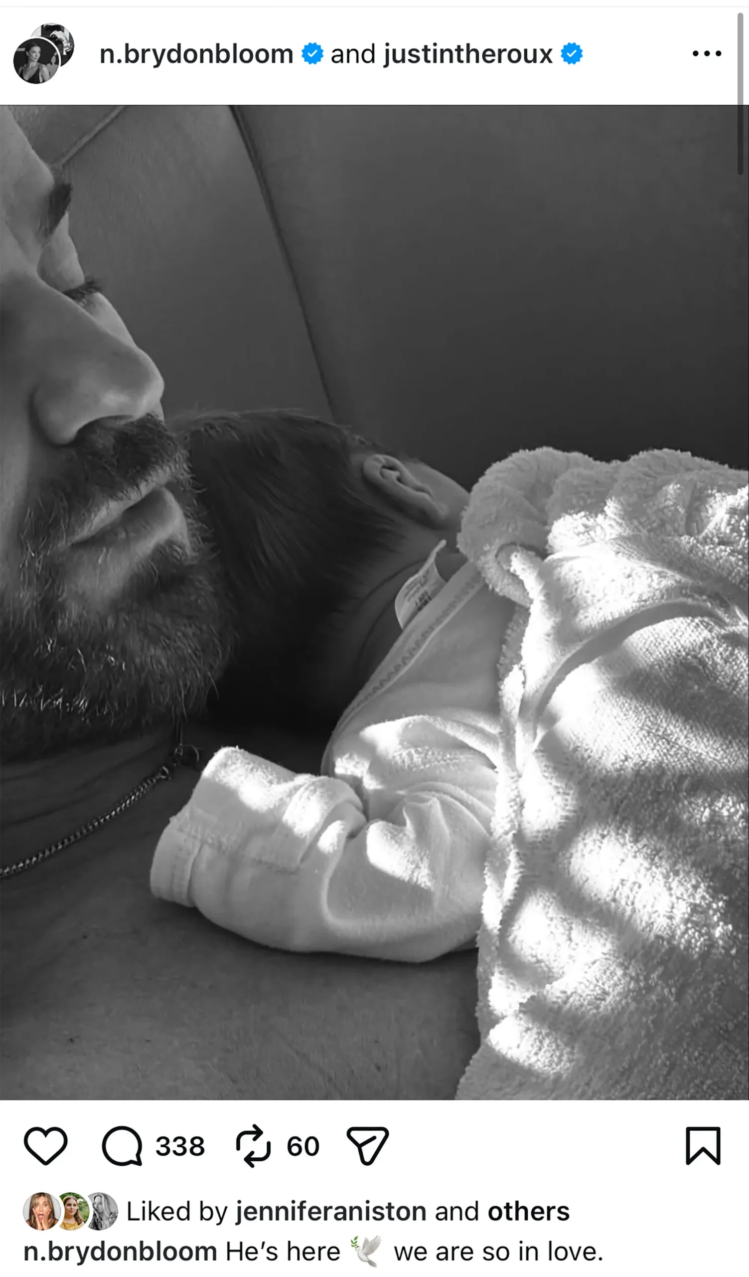 Black-and-white Instagram photo of Justin Theroux with a newborn resting on his chest.