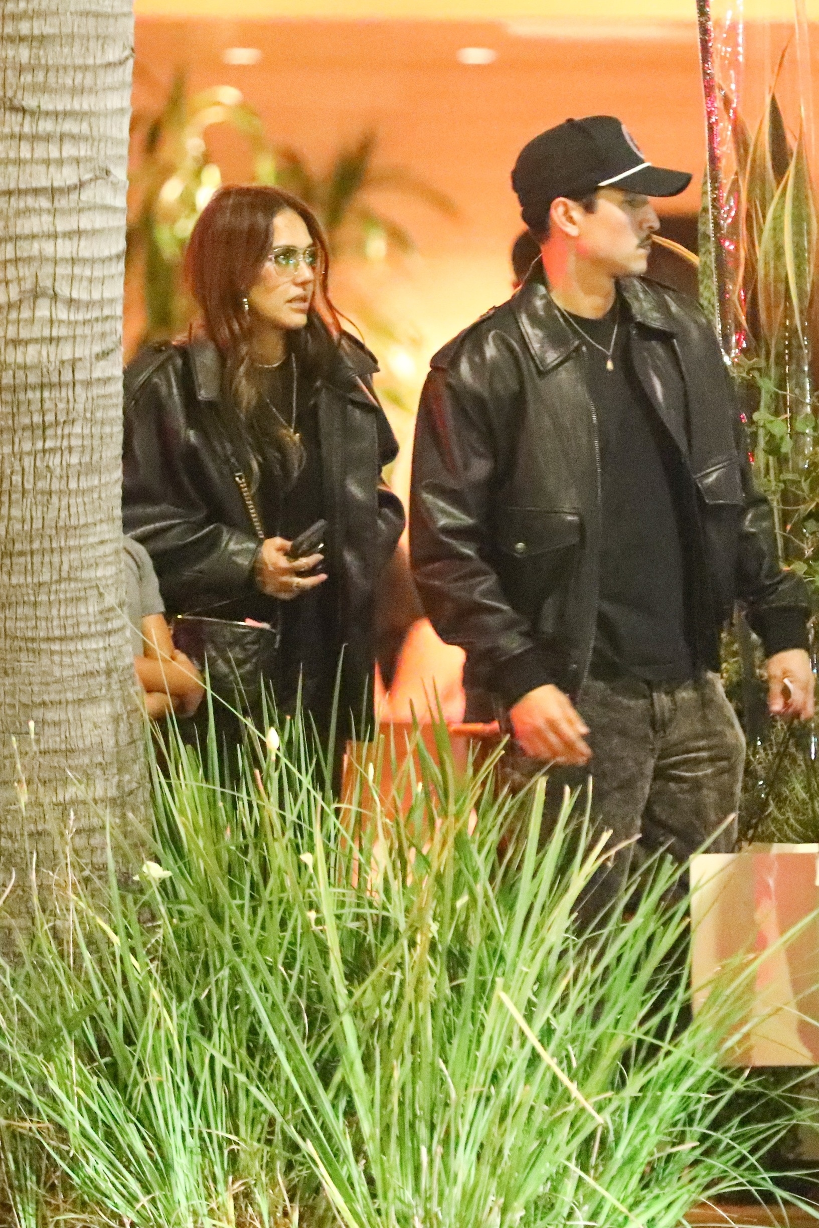 Jessica Alba and Danny Ramirez leave Avra in coordinating black leather jackets.